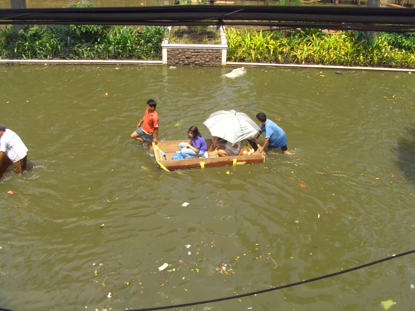 Residents on an improvised raft in deep floodwater, 2009